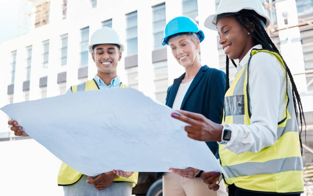 istock Architect, blueprint or building engineer meeting or planning architecture design strategy outside. Group diversity, construction teamwork or female property leader with real estate innovation vision 1433389454