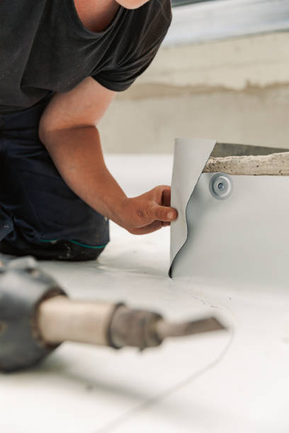 istock Worker specialized in mounting PVC membranes, TPO in the process of installing a water resistant system 1433389666