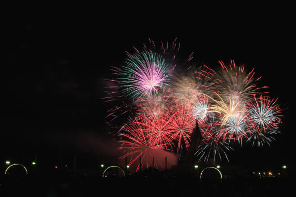 istock Multicolored fireworks in the dark sky, city day celebration. 1433390010