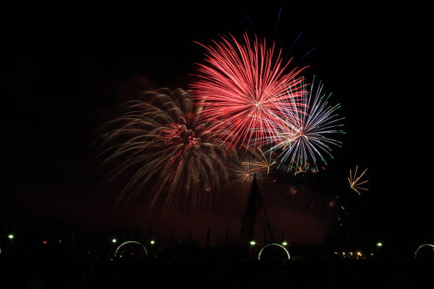 istock Multicolored fireworks in the dark sky, city day celebration. 1433390012
