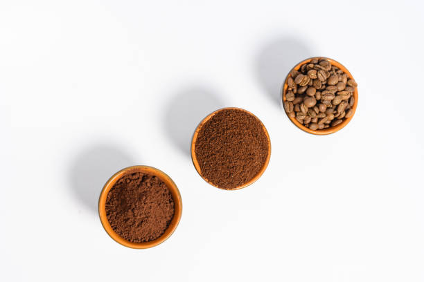 istock Three cups of coffee beans, ground coffee and cocoa for comparison. 1433393812