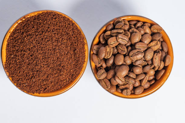 istock Cups with roasted coffee beans and ground coffee, white background and copy space. 1433394066