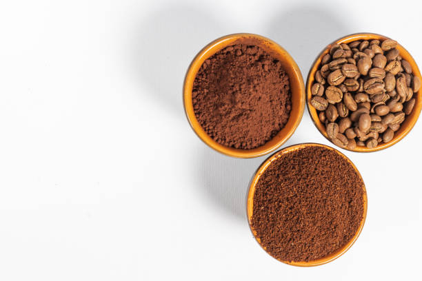istock Cups with roasted coffee beans and ground coffee, white background and copy space. 1433394098