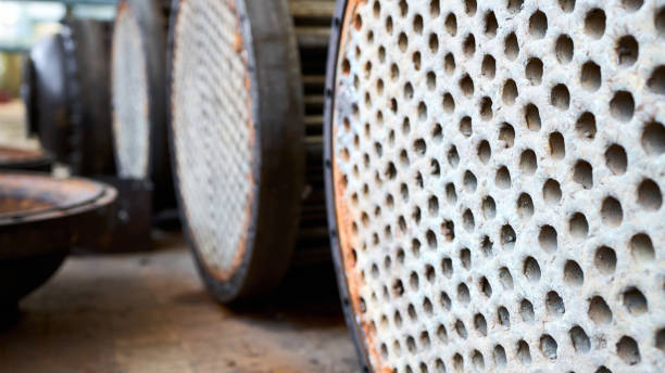 korrosion, raffineriewärmetauscher kühlrohre mit flanschsystem. reihe von industriellen wärmetauschern oder kesseln mit abdeckungen rostigen rohrblechen oder rohrplatten mit ablagerungen und korrosion. - heat exchanger stock-fotos und bilder