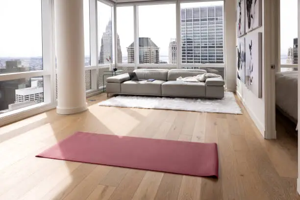 Photo of Empty living room in a modern apartment with a yoga mat