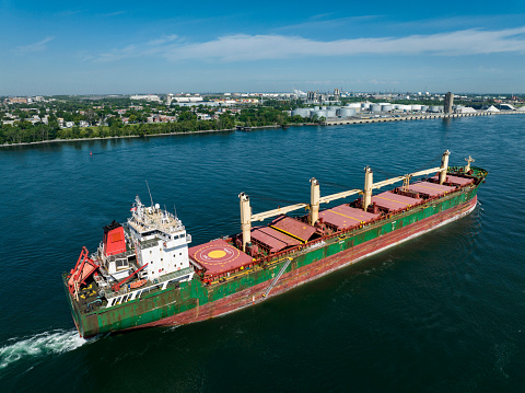 A fully loaded cargo ship leaving the Montreal Port and going downriver on the St.Lawrence River.