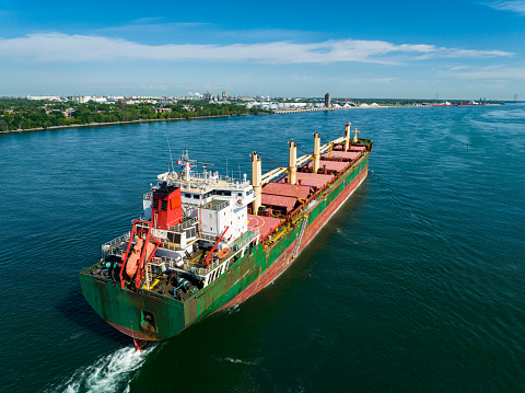A fully loaded cargo ship leaving the Montreal Port and going downriver on the St.Lawrence River.