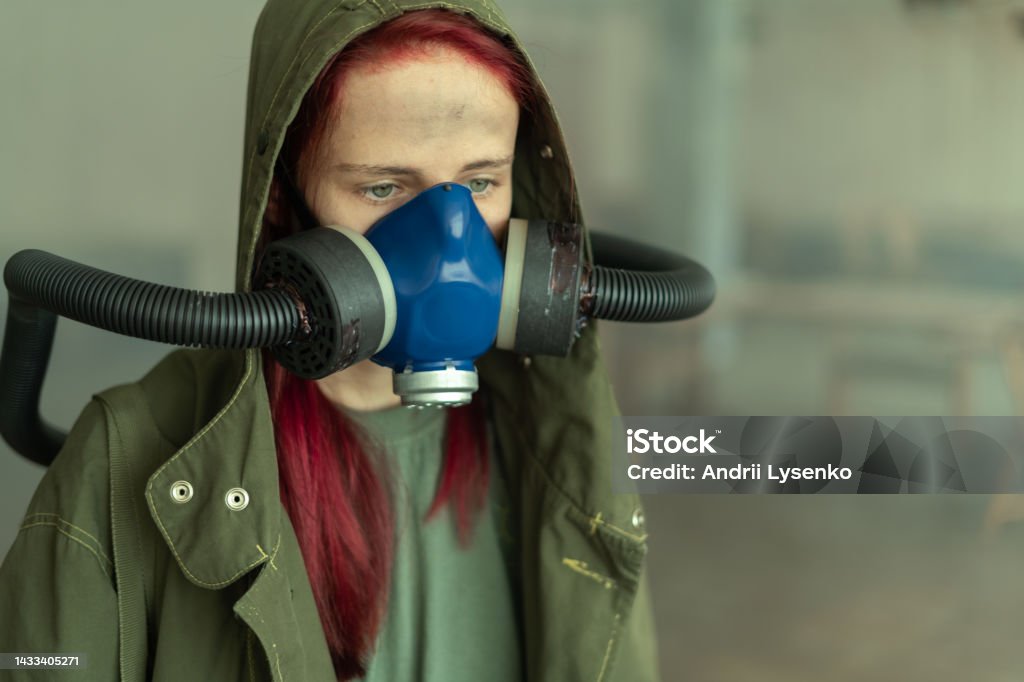 Post apocalypse female survivor in oxygen mask. Post apocalypse female survivor in oxygen mask. Close up Apocalypse Stock Photo