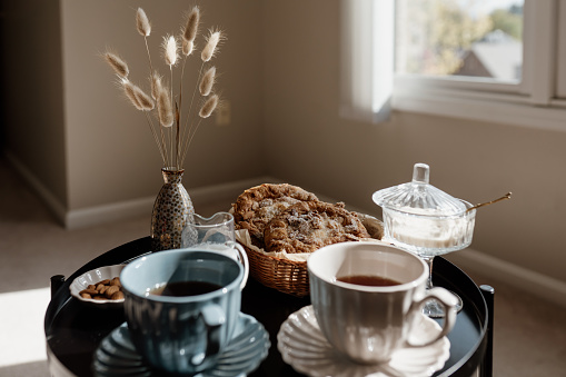 Aesthetic breakfast. Milk coffee, milk tea, sugar, almond, almond cakes, biscuits, marzipans and puffs. British breakfast in a cozy home. Autumn mood.