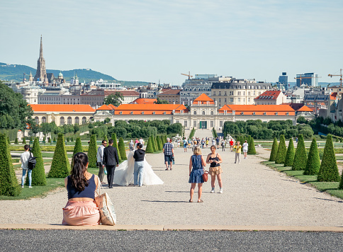 Vienna, Austria - June 2022: Tourists strolling on the alleys of the gardens of Belvedere Palace (Schloss Belvedere)