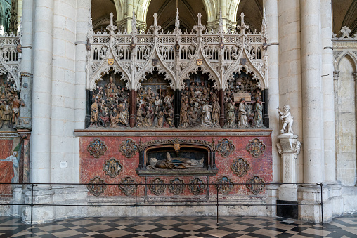 Amiens, France - 12 September, 2022: bishop's tomb and scenes from the life of Saint Firmin inside the historic Amiens Cathedral