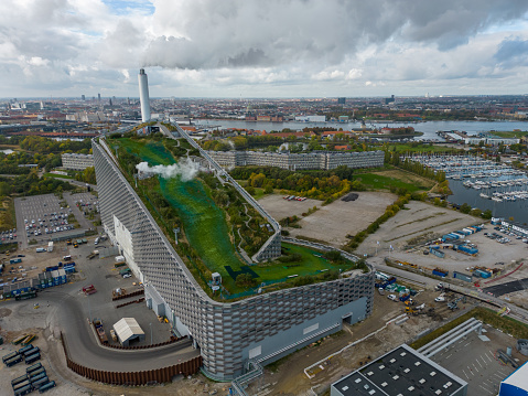 Aerial shot of energy plant Amager Bakke. Also known as Amager Slope or Copenhill, it's a combined heat and power waste-to-energy plant and sports facility with ski slope on the roof in Amager, Copenhagen, Denmark.