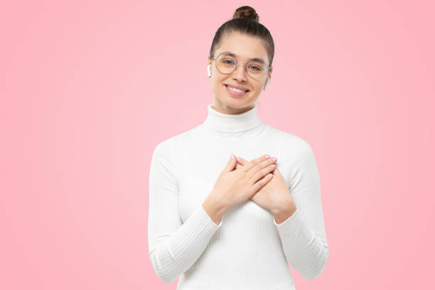 istock Female holding hands on chest, feeling gratefult, expressing heartfelt appreciation and gratitude 1433416517