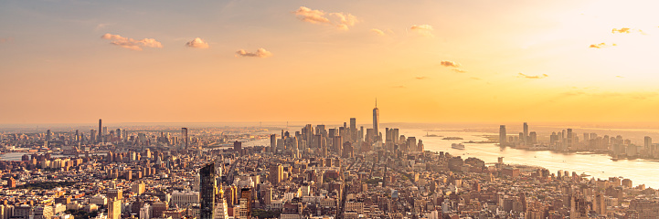 Golden sunset panorama aerial view of New York skyscrapers on Manhattan island.