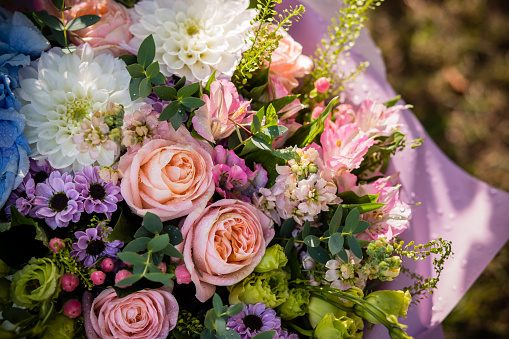 Beautiful emotional woman holding bouquet of flowers