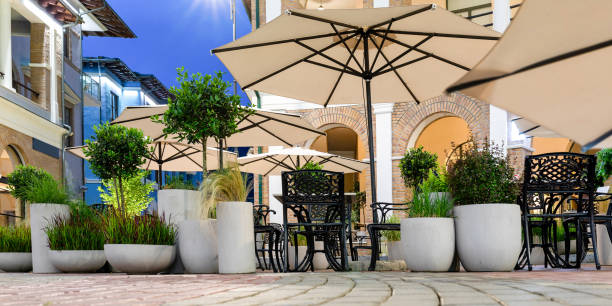 istock Empty terrace street restaurant with gray cement-concrete flowerpots with decorative grass Imperata cylindrica Red Baron in evening. Design, improvement of recreation area in urban environment 1433418444