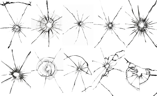 Set of bullet holes on white glass. Cracked texture of a shot window