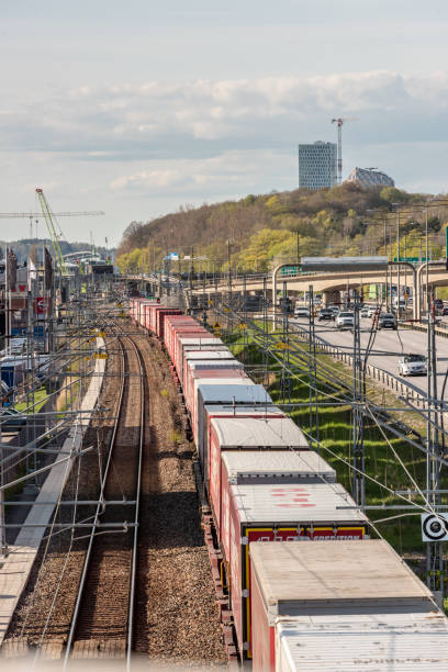 Gothenburg, Sweden - May 01 2022: Long container freight train moving southbound out of Gothenburg.