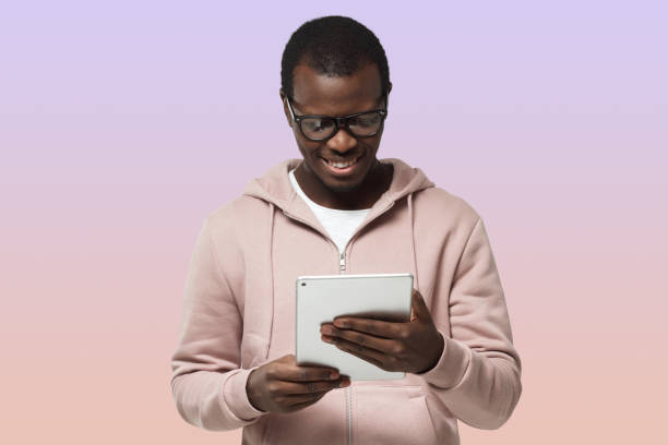 istock African guy looking at screen of tablet computer, experiencing digital opportunities of e-commerce 1433420990