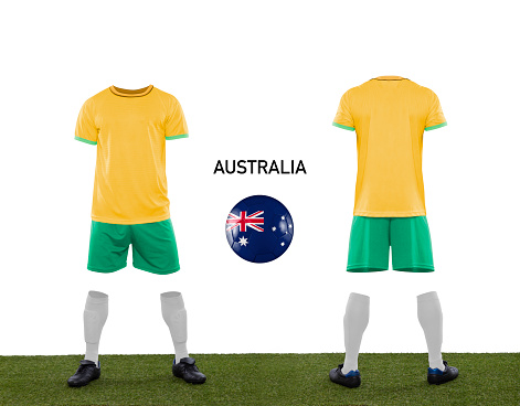 Uniform and ball with the flag of the Australia national team participating in Qatar 2022 with a grass floor on a white background.