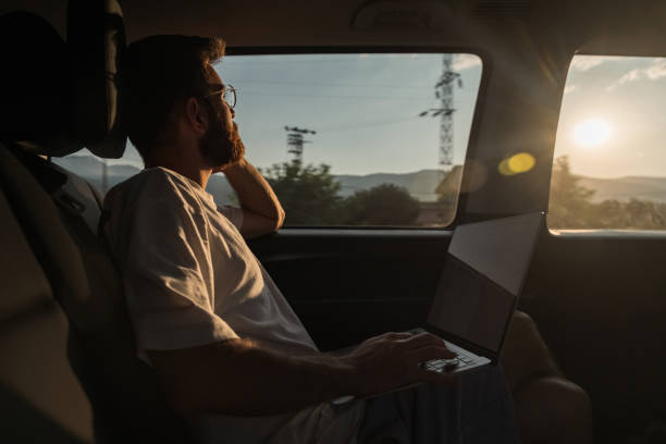 istock man working from her laptop while traveling in daylight in a private vehicle 1433425815
