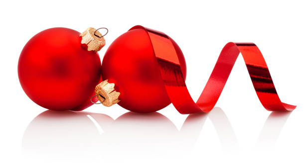 istock Two red Christmas baubles and curling paper Isolated on white background 1433426396