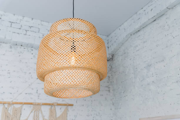 istock Pendant light with wicker lampshade, rustic style.Wicker shade lamp.Simple home interior with decorative ceiling wicker lamp.Decorating hanging lantern lamps in wooden from bamboo 1433426619