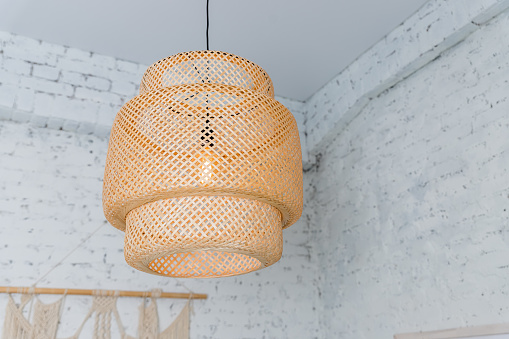Pendant light with wicker lampshade, rustic style.