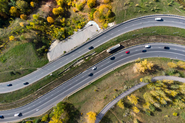vista aérea de la carretera con un bosque de otoño y una ranura en la carretera. - road winding road mountain spiral staircase fotografías e imágenes de stock