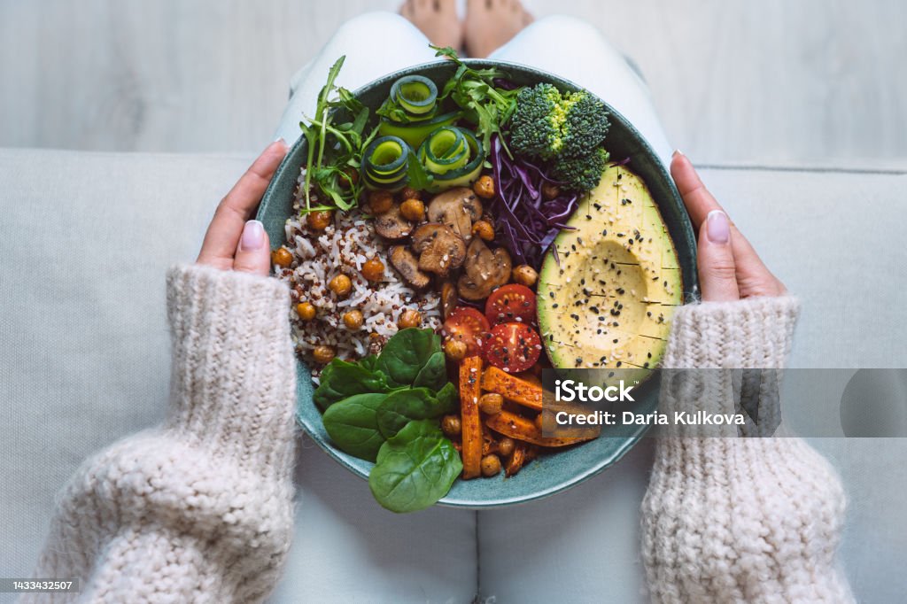 Healthy eating. Plate with vegan or vegetarian food in woman hands. Healthy plant based diet. Healthy dinner. Buddha bowl with fresh vegetables Healthy eating. Plate with vegan or vegetarian food. Healthy plant based diet. Healthy dinner. Buddha bowl with fresh vegetables. High quality photo Healthy Eating Stock Photo