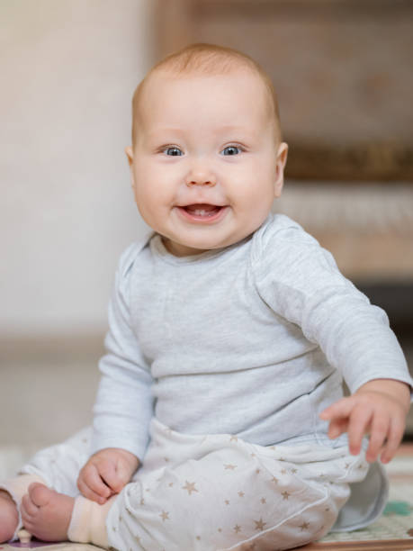 istock Baby girl enjoys playing in room with smiling expression 1433434175