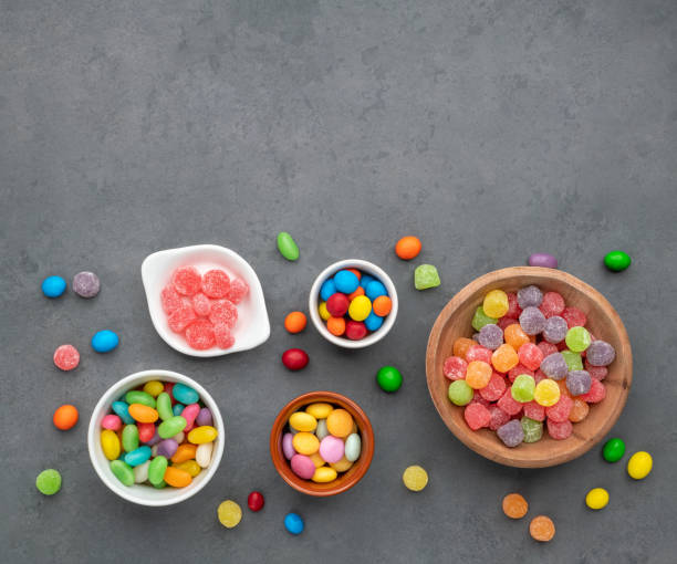 istock Assorted colorful candies in bowls over stone background with copy space 1433434847