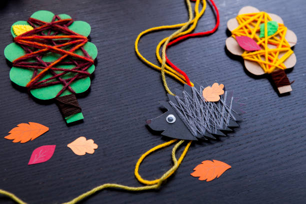 istock Art and handswork for children with woolen threads, leaves, herbarium, tree, hedgehog 1433437241