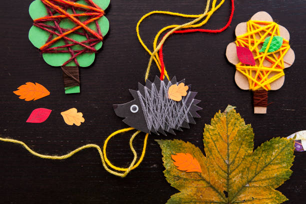 istock Art and handswork for children with woolen threads, leaves, herbarium, tree, hedgehog 1433437259