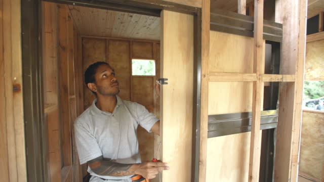 Carpenter installing sliding door
