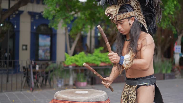 Aztec performer playing the drum outdoors