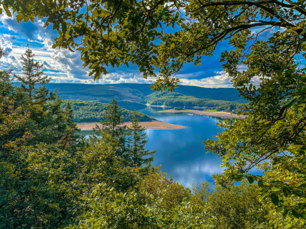 View of the Ruhr dams from behind the trees and branches with very low water level