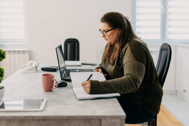 istock Beautiful student with eyeglasses having an online lesson 1433445204