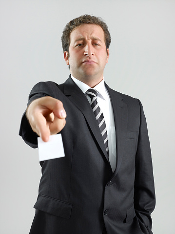 Businessman showing his business card.