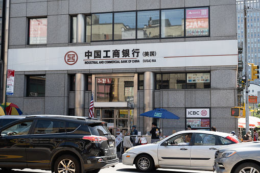 New York, NY, USA - June 8, 2022: An ICBC (Industrial and Commercial Bank of China) branch in Chinatown, with a sign with Chinese characters.
