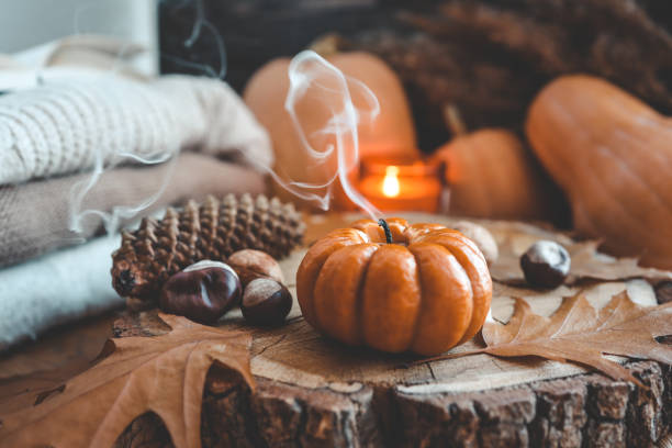 istock Smoke from an extinguished candle and a cup of tea, autumn composition 1433449715