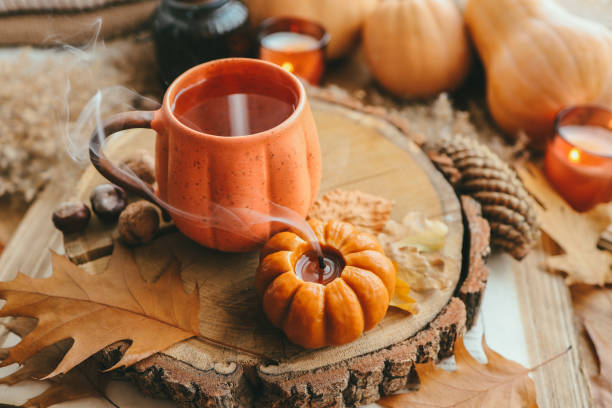 istock Smoke from an extinguished candle and a cup of tea, autumn composition 1433449717