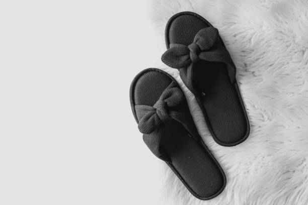 Home slippers on a white fluffy carpet