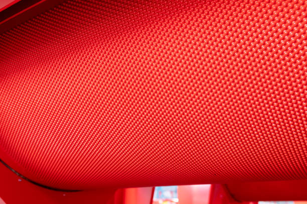 istock Fragment of a grain separation machine. Red metallic cell pockets sheet rolled into a cylinder 1433453178
