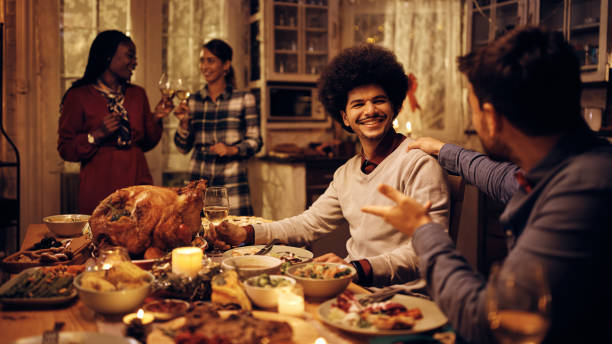 istock Happy Middle Eastern man enjoying in Thanksgiving dinner with friends at dining table. 1433454002