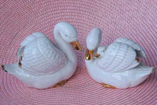 istock two small figurine of a white ceramic swans 1433460551