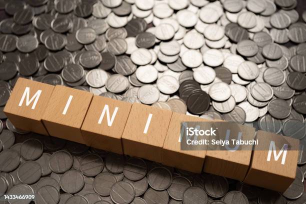 Wooden Blocks With Minimum Text Of Concept And Coins Stock Photo - Download Image Now