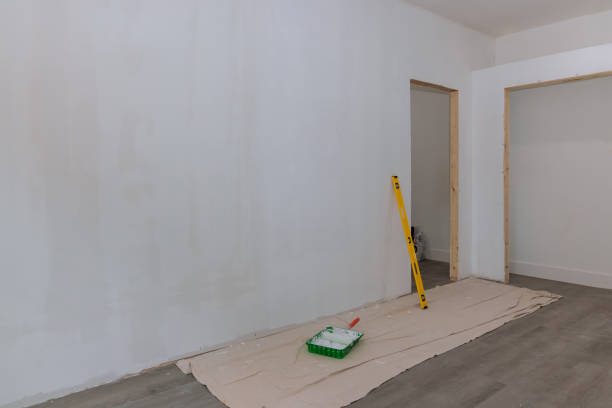 After a primer has been applied to the newly constructed homes walls, the gypsum plaster walls are ready to be painted stock photo