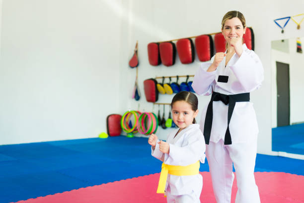 istock Smiling female martial arts trainer with a kid student 1433470209