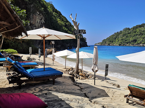 Beach chairs at the idyllic Atuh beach, on the coast of Nusa Penida island, Bali, Indonesia